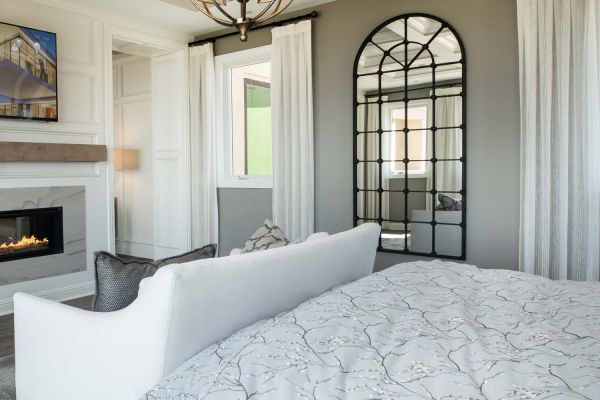 Bedroom with motorized shades and Control4 interface on the TV