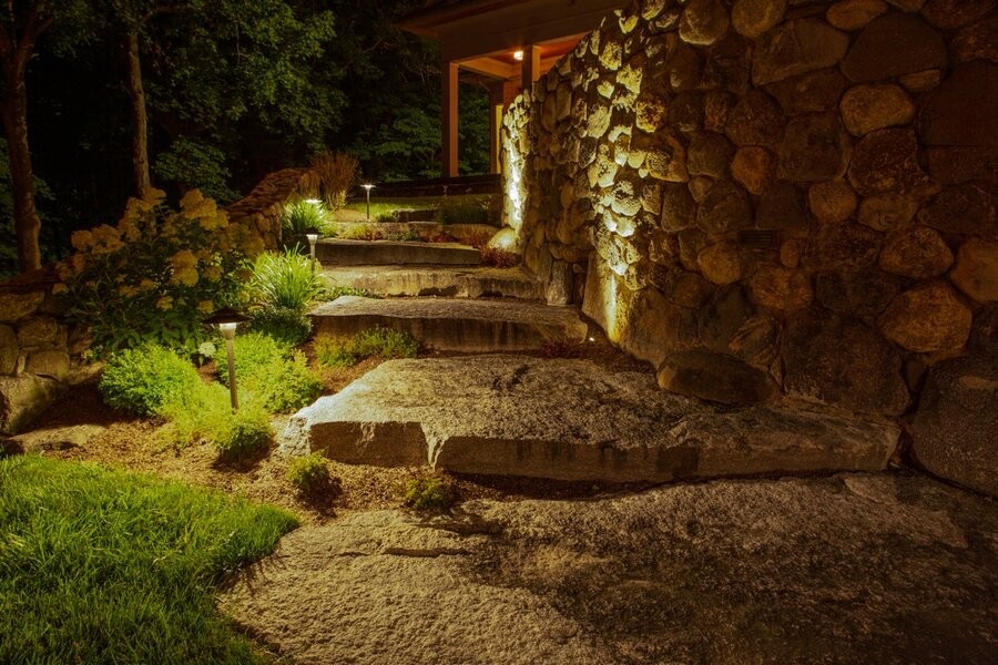 A stair pathway illuminated by Coastal Source landscape lighting.