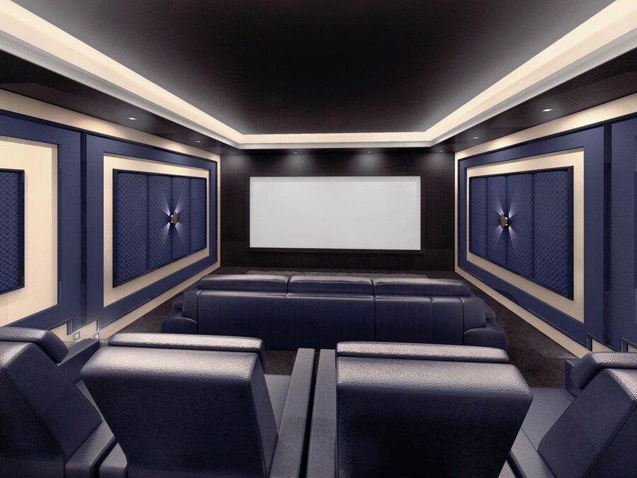 A professional home theater setup with a large screen, acoustic panelings, and comfy seating.
