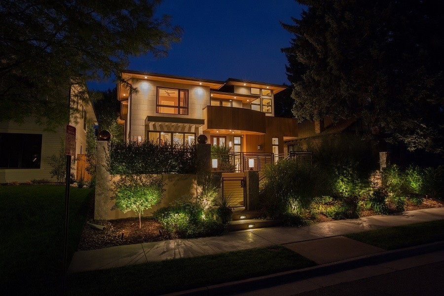 A home illuminated with landscape lighting. 