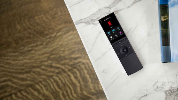 control4 Neeo remote that's black laying on a table