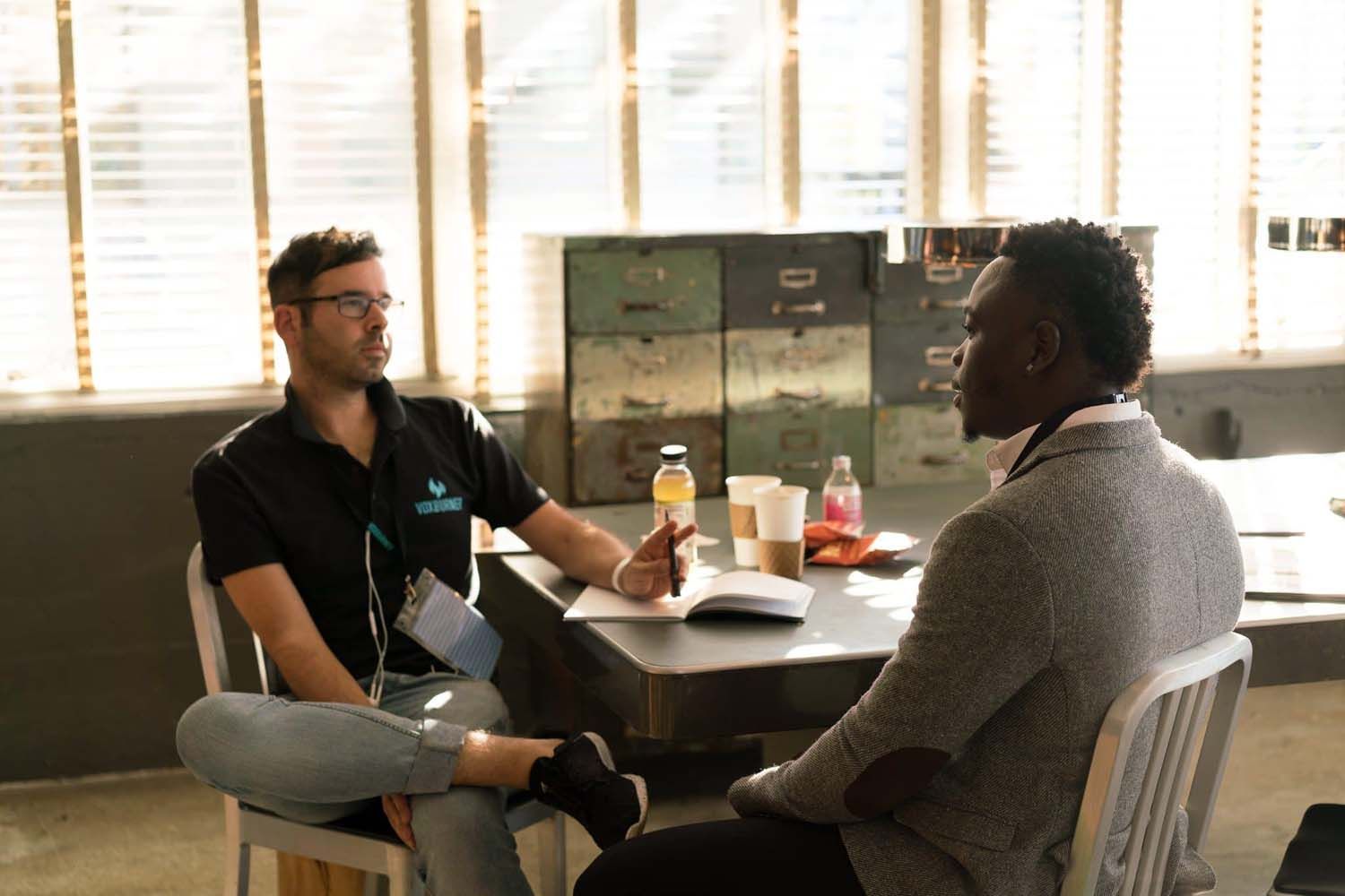 two men discussing ideas over coffee