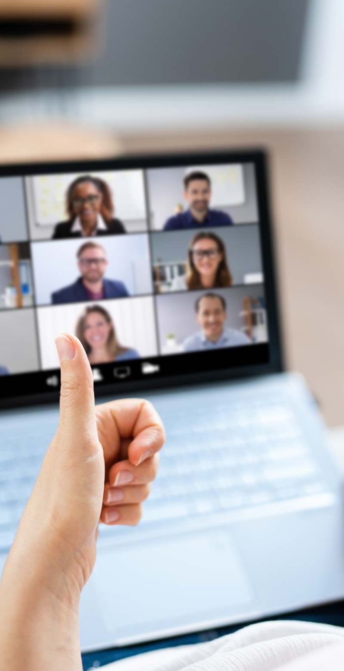 person giving a thumbs up to a zoom call