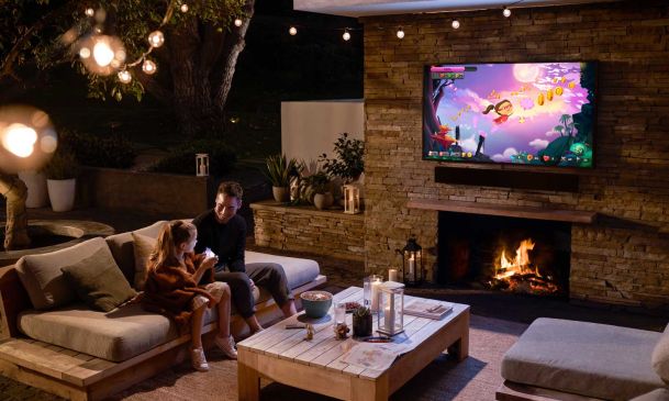 father and daughter sitting on the porch at night playing games