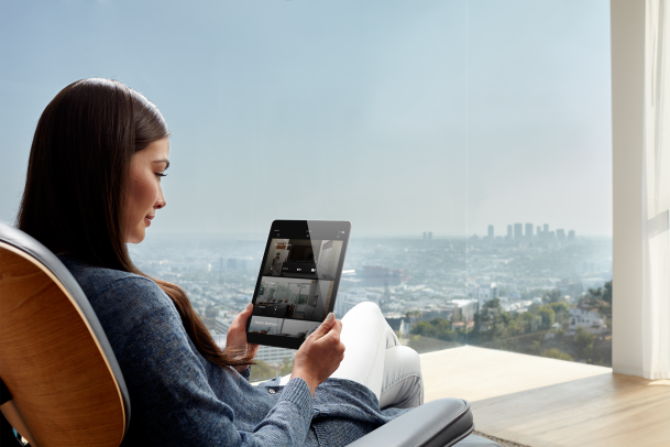Woman using an ipad with Savant interface